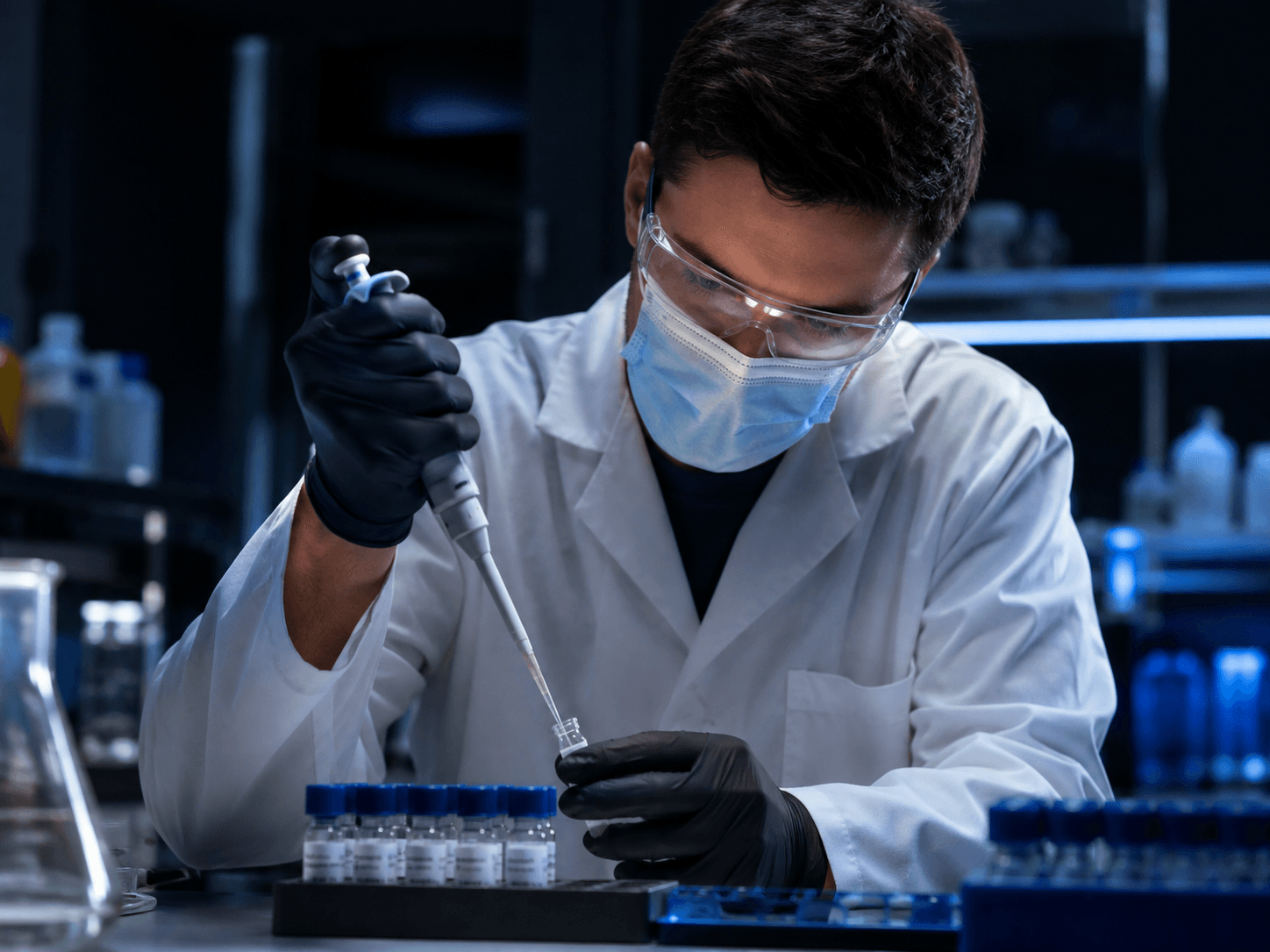 Laboratory researcher performing testing with a micropipette